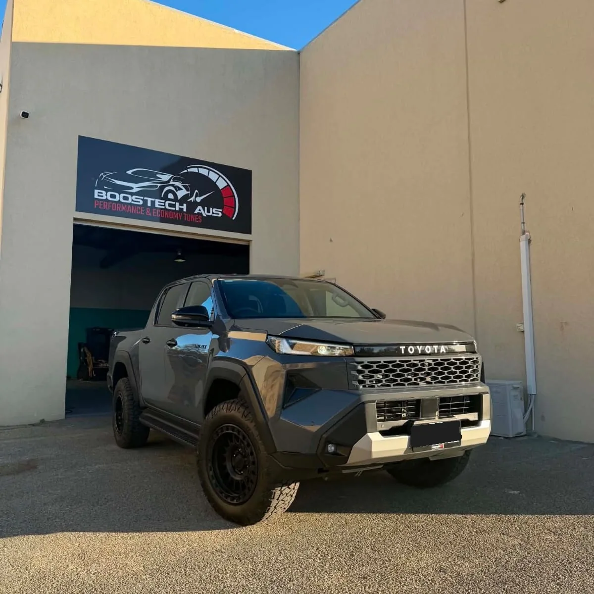 Grey Toyota Hilux outside a workshop with Boostech AUS signage