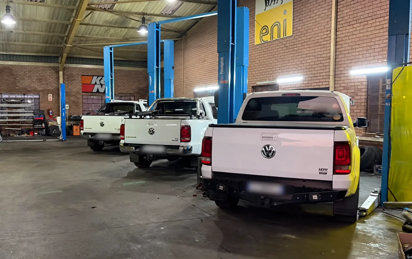 Three Volkswagen Amaroks lined up inside the Johannesburg workshop
