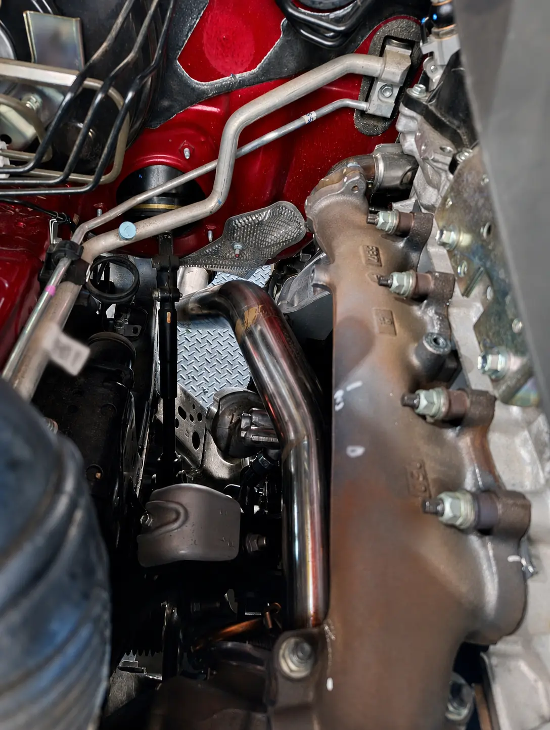 Close-up of a professionally fitted performance downpipe