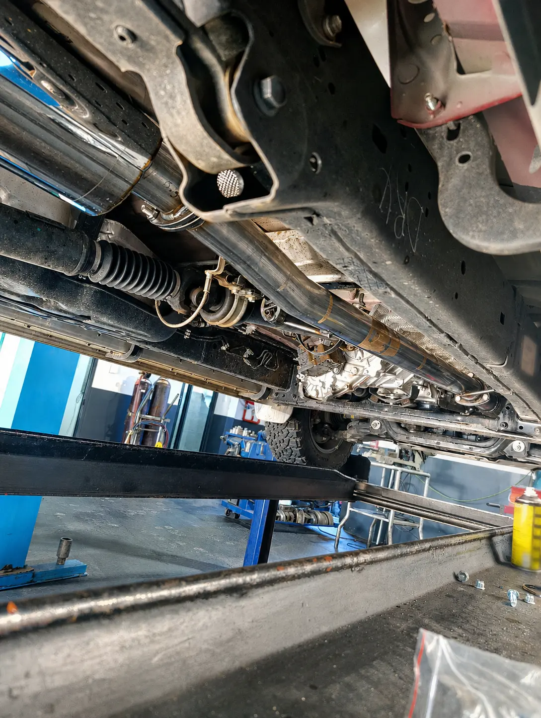 Installed performance exhaust viewed beneath a vehicle